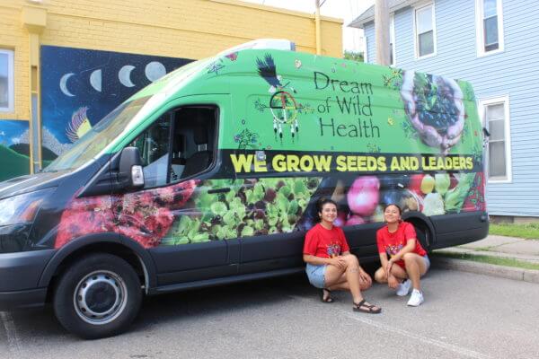 people smiling in front of the Dream of Wild Health van