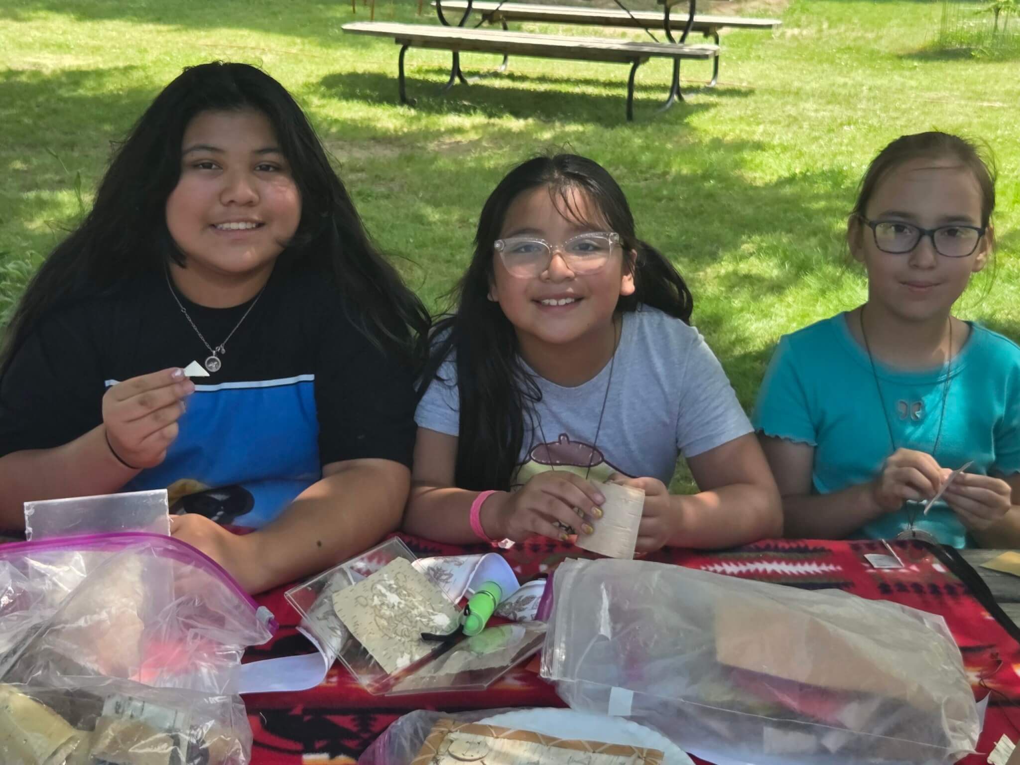 kids smiling while at a table working on an activity